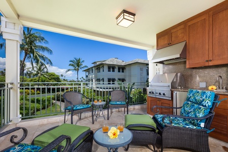 - Covered lanai with wicker seating, tropical cushions, and built in grill station   - Open railing design offers sweeping views of palm trees and blue skies   - Perfect for enjoying fresh island air while dining or relaxing outdoors