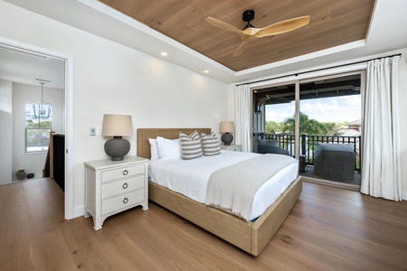Drift into peaceful slumber in your elegant bedroom featuring a plush king bed and private balcony overlooking tropical greenery.