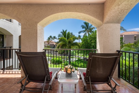 Unwind in your private balcony sanctuary, where comfortable seating frames tropical views of swaying palms and lush gardens.