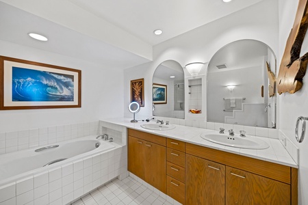 Spa-like bathroom with separate tub and shower, dual vanities, and bright, spacious design.