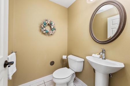 Refresh in your bright, welcoming powder room with coastal touches and modern fixtures that keep things simple and clean.