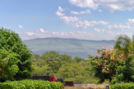 Stunning mountain views frame the lush tropical gardens surrounding the property, creating a serene natural backdrop.