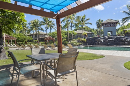 Relax at your private patio table with shade overhead, overlooking the sparkling pool and tropical gardens.