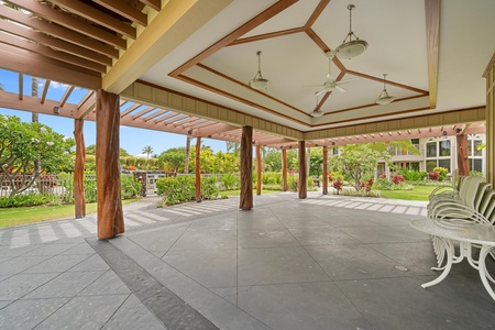 - Spacious covered pavilion with stylish wood accents and ceiling fans for comfort - Open air design provides a cool shaded space to gather or enjoy the scenery - Surrounded by greenery creating a peaceful and relaxing atmosphere