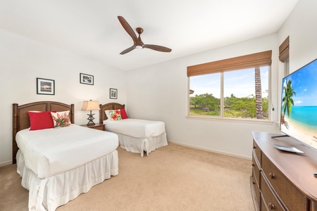 Your comfortable twin bedroom features tropical-style beds, tropical views, and a peaceful ceiling fan for restful nights.