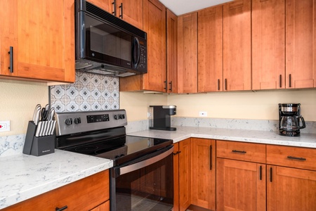 Full kitchen with breakfast bar, granite counters, and modern appliances