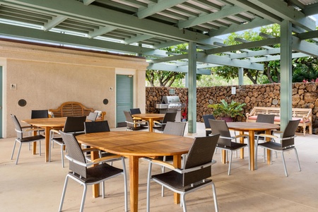 Covered outdoor dining area with extra seating for gatherings.