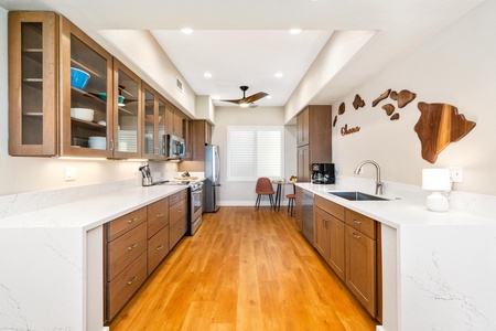 - Spacious galley kitchen with sleek wood cabinets & pristine white countertops for style - Fully equipped with stainless steel appliances & extra storage for cooking needs - Recessed lighting & ceiling fan keep the space bright airy & comfortable