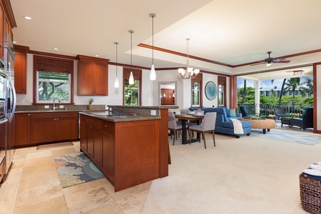 - Open concept kitchen and living space with warm wood tones and modern lighting   - Granite counters and spacious island offer plenty of prep space   - Flows into dining and seating areas for a connected entertaining experience