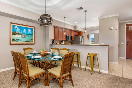 Your open-concept dining and kitchen space blends tropical charm with modern comfort, featuring a beautifully set table ready for memorable meals.