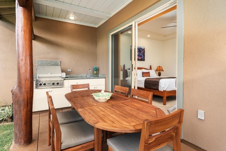 Your private covered patio seamlessly blends indoor-outdoor living with a beautiful teak dining set and built-in grill for memorable meals.