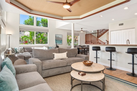 Unwind in your bright, open living space with plush seating and tropical garden views through expansive windows.