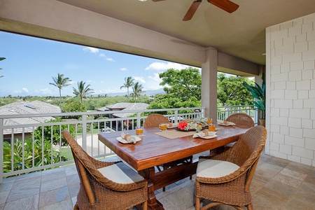 - Alfresco dining table set for breakfast with beautiful palm views all around   - Four wicker chairs and natural wood table create a cozy tropical retreat   - Open air space with ceiling fan keeps the ocean breeze flowing freely