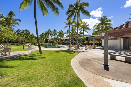 Tropical paradise with pristine pool, swaying palms, and manicured lawns creates the perfect Hawaiian escape for relaxation and recreation.