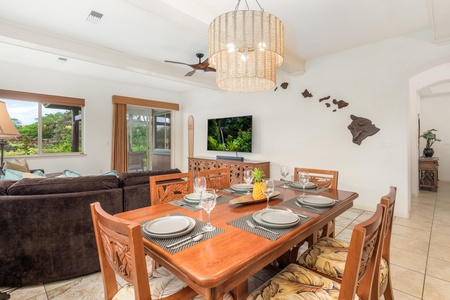 Gather around your elegant dining table for memorable meals while enjoying tropical views through large windows and island-inspired décor.