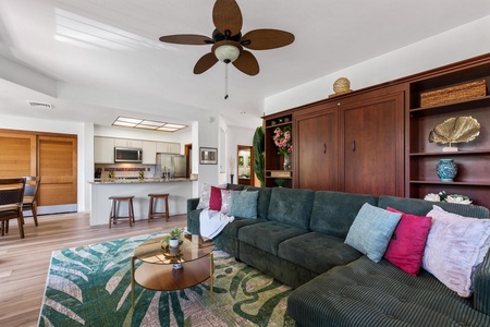 Sink into your oversized teal sofa beneath tropical ceiling fans, with a fully equipped kitchen steps away. Open-plan design and natural light create your perfect home base.
