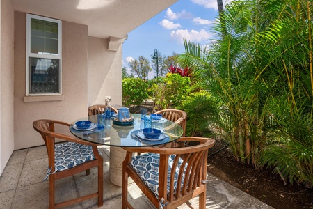 Covered lanai with table offers a relaxing spot for casual outdoor dining.