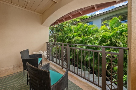 - Covered balcony featuring two wicker chairs and tropical garden views - Arched openings frame greenery for a tranquil, secluded setting - Ideal for unwinding with a drink while enjoying the fresh air