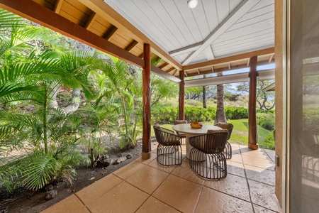 Your covered patio offers the perfect tropical dining escape, surrounded by lush palms and garden views for memorable outdoor meals.