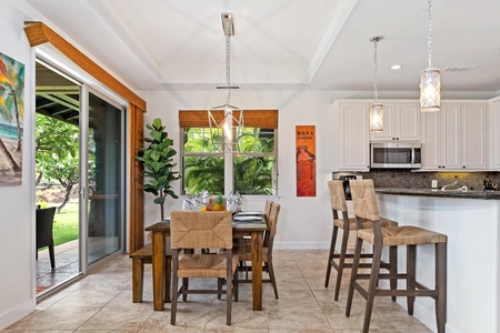 Dining area with sliding doors to lanai and breakfast bar