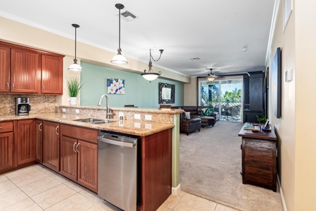 Full kitchen with breakfast bar, granite counters, and stainless steel appliances