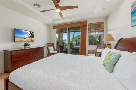 Wake up refreshed in your elegant bedroom with luxury linens, warm wood accents, and a private balcony overlooking tropical greenery.