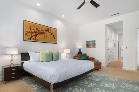 - Relax in a serene king suite featuring beachy décor and calming tones - Sleek leather chaise invites cozy lounging beneath ocean art - Statement cherry blossom artwork brightens the wall above the bed