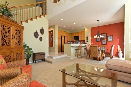 - Open living space with view of kitchen, dining, and breakfast bar seating - Warm tones and natural light create a welcoming, spacious feel - Perfect layout for entertaining or relaxing with family and friends