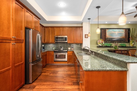 Full kitchen with breakfast bar, granite counters, and stainless steel appliances
