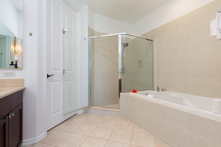 - Refresh in a spacious bathroom featuring a walk in glass shower and large soaking tub - Neutral tile tones and bright lighting create a spa inspired atmosphere - Convenient layout connects seamlessly to the bedroom retreat nearby
