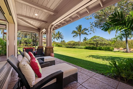 - Enjoy serene mornings on the shaded patio with beautiful lawn and palm views - Cushioned loungers and rattan seating invite alfresco relaxation - Perfect setting to unwind in paradise surrounded by greenery