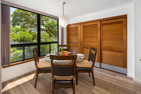 Gather around the elegant dining table with garden views streaming through the window, where sunlight and greenery create the perfect backdrop for your morning coffee or evening meals.