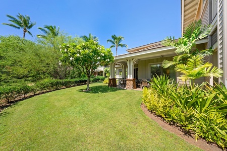 Covered lanai with garden views, dining table, and BBQ