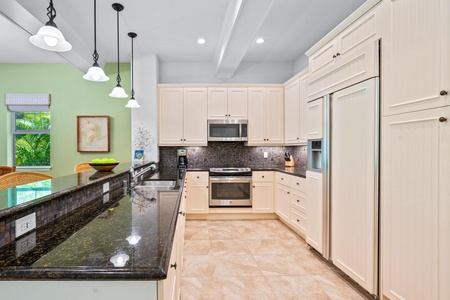 Full kitchen with breakfast bar, granite counters, and modern appliances