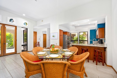 - Glass top dining table with six wicker chairs sits perfectly beside the open kitchen - Natural textures and garden views create an inviting, tropical dining atmosphere - Ideal for group meals, holiday feasts, or everyday family breakfasts