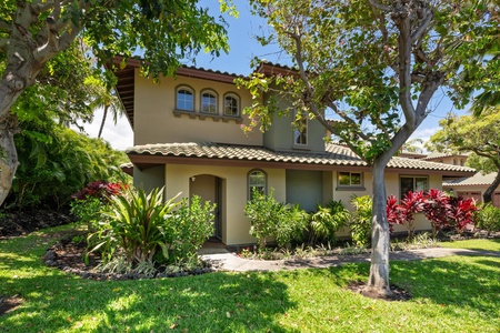Side view of the villa with arched windows and tropical landscaping for added privacy.