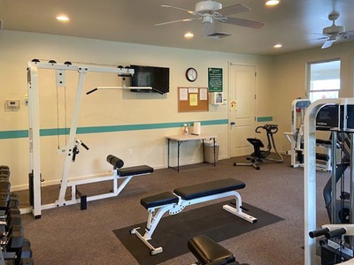 Well equipped fitness area with weights and training machines.