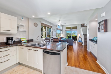 - Enjoy seamless flow from kitchen to living space in this open concept design - Glassware and dishes are neatly displayed on floating shelves for convenience - Cook while staying connected with guests in the sunlit lounge beyond