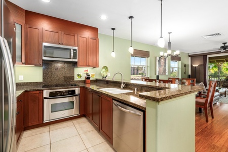 Full kitchen with breakfast bar, granite counters, and stainless steel appliances