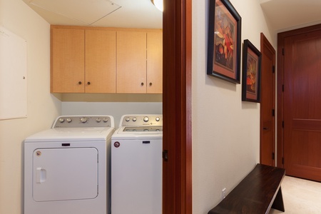 - Convenient laundry area with full size washer and dryer for guest use - Overhead cabinets provide storage for essentials during extended stays - Located near bedrooms for easy access during your visit
