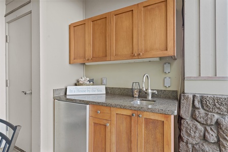 Your compact kitchen features warm wood cabinetry, granite countertops, and everything you need to prepare meals during your stay.