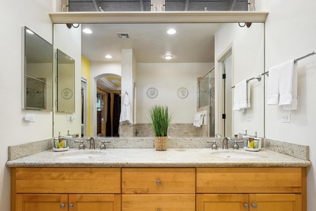 Spacious bathroom features dual sinks, granite countertops, separate shower & soaking tub.
