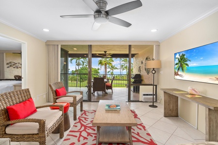 - Lounge on the sofa or chairs with views of the TV and outdoor dining beyond - Large glass sliders frame the tropical landscape and let in natural light - Stylish ceiling fan and coastal decor make this room a laid back retreat