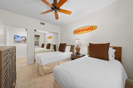 Sink into crisp white linens in your twin bedroom, where wicker headboards and beach vibes create the perfect coastal retreat.