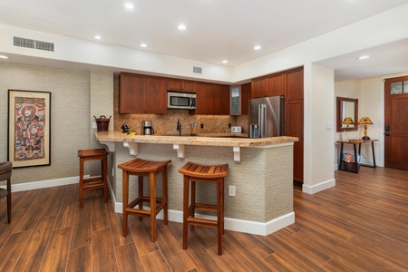 Your open kitchen features rich wood cabinetry and a breakfast bar where you can enjoy morning coffee or casual meals together.