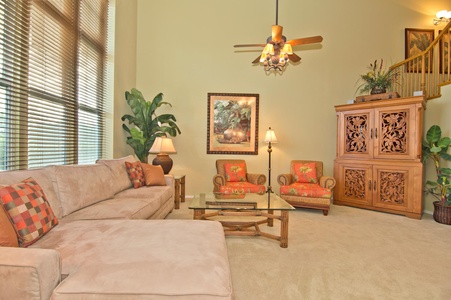 - Comfortable living area with sectional sofa and tropical accent chairs - Large windows fill the space with light, enhancing the airy feel - Ideal for relaxing after a day of exploring or enjoying the outdoors