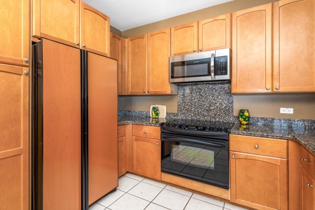 Your fully equipped kitchen features granite countertops, modern appliances, and ample cabinet space—perfect for preparing meals during your stay.