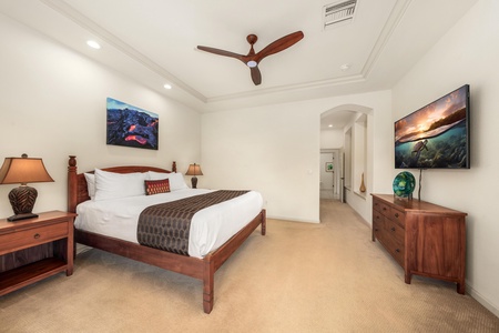 Drift off peacefully in your elegant bedroom, where rich wood furnishings and ocean artwork create a serene coastal retreat.