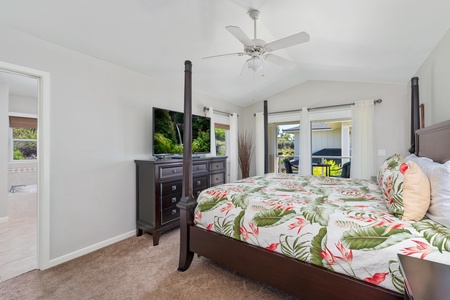 - Wake up to natural light and patio views from this beautifully styled bedroom - Watch your favorite shows on a large flat screen TV atop a dark wood dresser - Relaxing escape with tropical bedding and plush carpeting underfoot