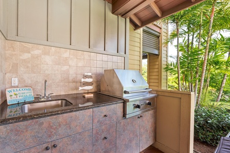 Fire up your outdoor culinary adventures at this beautifully appointed BBQ station, complete with granite counters and tropical garden views.